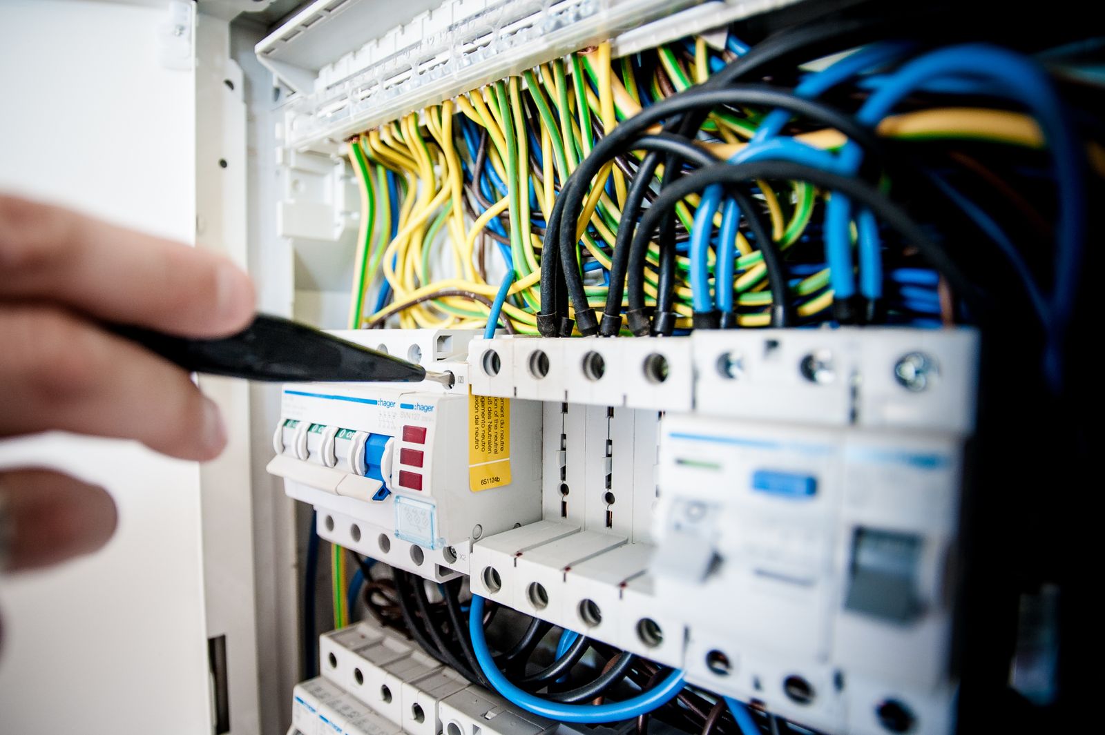 Electrician working on electrical wiring and switchboard